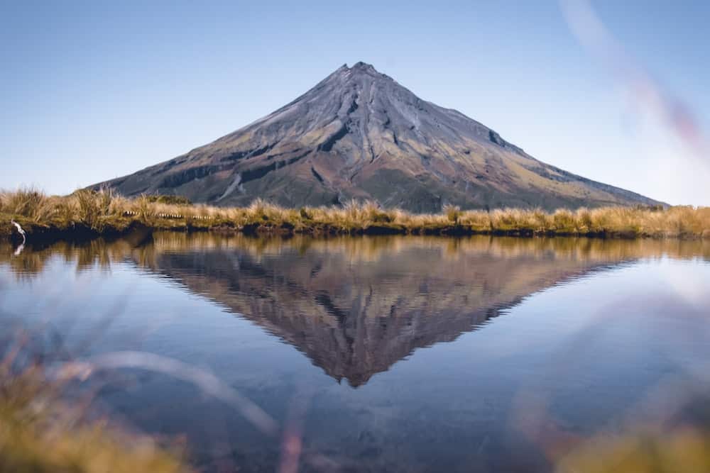 Picture of mountain mirrored in water to reflect the peace that comes when you are equipped as a skilled energy healing practitioner and feel confident with your energy healing certification.