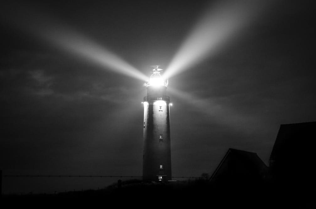 A lighthouse shining in the dark